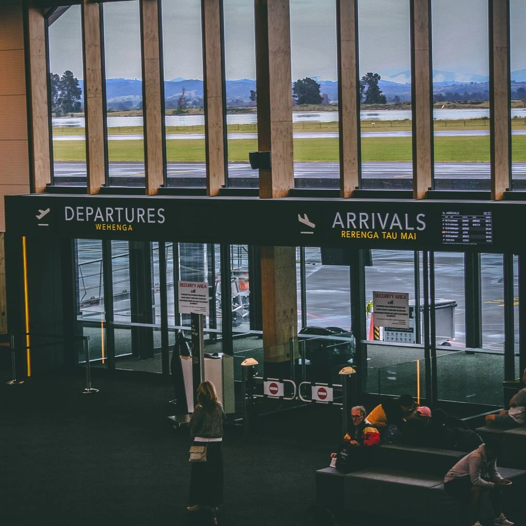 A first-time traveler consulting a hand-marked map at a small international airport.
